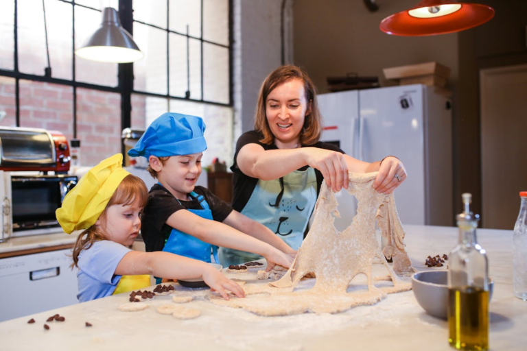 Two kids in a cooking class with an instructor