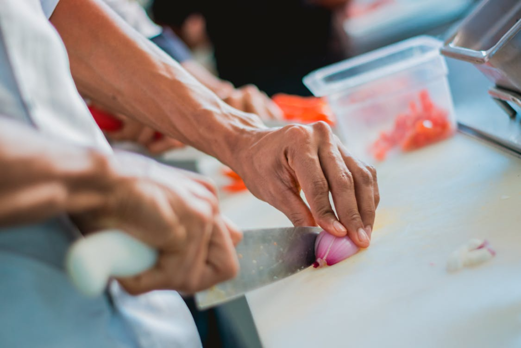 Close-up of a chef chopping an onion