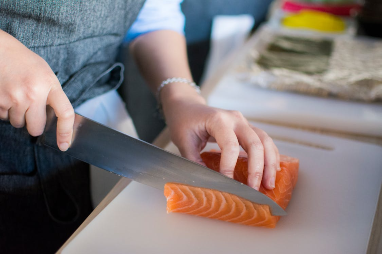 A person slicing on a chopping board